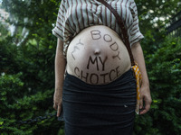 My body, my choice appears on a pregnant womans stomach during a protest against the Supreme Courts decision to overturn Roe V. Wade on Frid...
