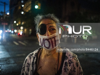 A protestor wears a vote mask during a protest against the Supreme Courts decision to overturn Roe V. Wade on Friday June 24, 2022 in New Yo...