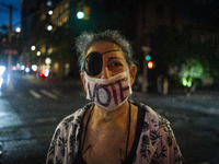 A protestor wears a vote mask during a protest against the Supreme Courts decision to overturn Roe V. Wade on Friday June 24, 2022 in New Yo...
