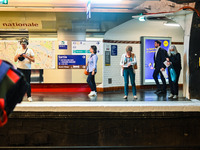 People waiting for the metro on the platform. Daily life in Parisian metro, as France faces an increase of Covid19 cases. . (Photo by Adrien...