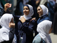 Palestinian students celebrate the last day in their final high school exams, known as ''Tawjihi'', in Gaza city on July 04, 2022.  (