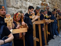 JERUSALEM, ISRAEL - APRIL 18: Orthodox Christian pilgrims carry crosses along the Via Dolorosa on April 18, 2014 in Jerusalem's old city, Is...