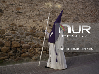 A penitent takes part in a Holy week  procession called the 