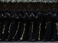 Penitents take part in a Holy week  procession called the 