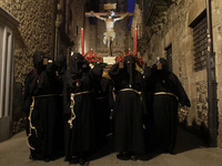 Penitents take part in a Holy week  procession called the 
