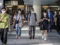 People wearing Face mask walking on a footbridge in Wan Chai District on July 12, 2022 in Hong Kong, China. The Hong Kong Government announc...