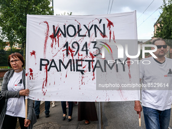 People hold a banner reading 'Volhynia. 1943. We remember.' during a commemoration service of Polish victims of Ukrainian genocide commited...