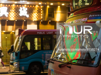 Hong Kong, China, 3 Jul 2022, A LED sign can be seen reflected in the windshield of a red minibus. (