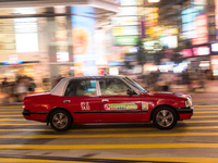 Hong Kong, China, 15 Jul 2022, A taxi rushes in this panned shot in Causeway Bay. (