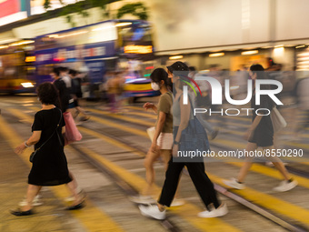 Hong Kong, China, 15 Jul 2022, People cross the street in Causeway Bay. (