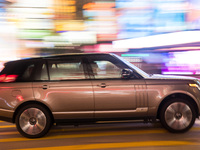 Hong Kong, China, 15 Jul 2022, A Range Rover SUV passes in Causeway Bay in this panned shot. (