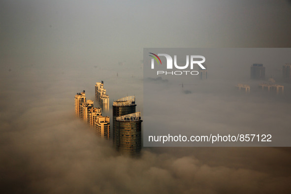 RIZHAO, Oct. 19, 2015 () -- Buildings are enveloped by fog in Rizhao, a coastal city in east China's Shandong Province, Oct. 18, 2015.  