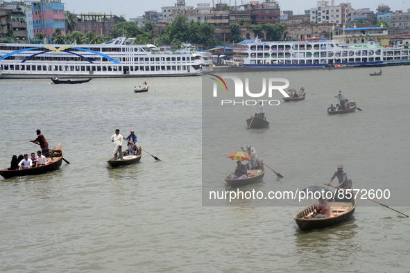 People cross the busy Buriganga river by boat during high temperature weather in Dhaka, Bangladesh, on July 22, 2022 