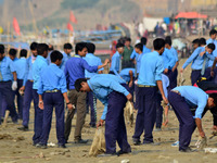 Indian school students clean the garbages on the banks of River Ganges under programme of National Mission For Clean Ganga (NMCG),in Allahab...