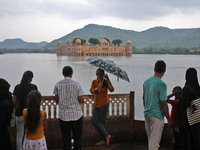 People visit the Jal Mahal during the monsoon season in Jaipur, Rajasthan, India, Sunday, July 24, 2022.(