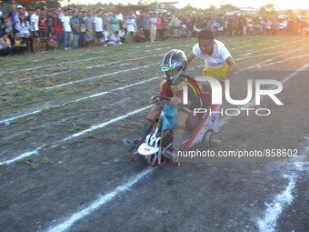 A tribal Naga man pushes a cart as they make way during an indigenous cart rally at the Ao Students Union Dimapur Sport Meet in Dimapur, Ind...