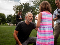 Veterans advocate Jon Stewart talks with Brielle Robinson, 9, following a press conference on the Republican defeat of the Honoring Our PACT...