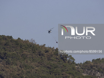 Mil Mi-8 firefighting helicopter with a water basket as seen in Dadia forest. Wildfires in Greece as a heatwave is going on. Dadia National...