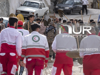 Members of the Islamic Revolutionary Guard Corps (IRGC) and members of the Iranian Red Crescent Society (IRCC) arrive at the flooded village...