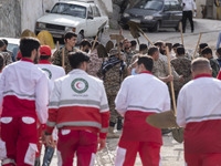 Members of the Islamic Revolutionary Guard Corps (IRGC) and members of the Iranian Red Crescent Society (IRCC) arrive at the flooded village...