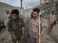 Members of the Islamic Revolutionary Guard Corps (IRGC) arrive at the flooded village of Imamzadeh Davood in the northwestern part of Tehran...