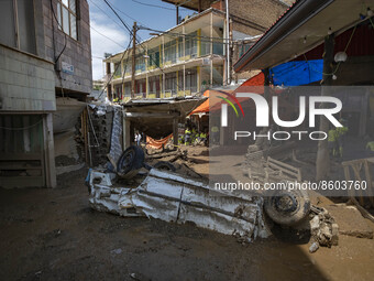 A view of a vehicle which is damaged caused of flash flooding is pictured in the flooded village of Imamzadeh Davood in the northwestern par...
