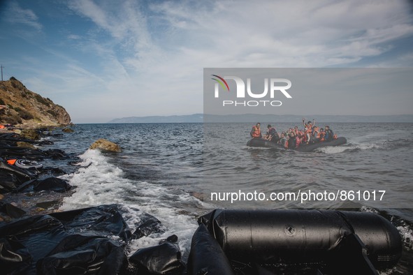 A boat full of migrants reaches on the shores of Lesbos, Greece from Turkey, on September 26, 2015.  