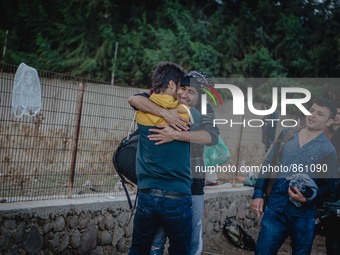 Two men embrace in a hug after a successful crossing from Turkey to Lesbos, Greece, on September 29, 2015.  (