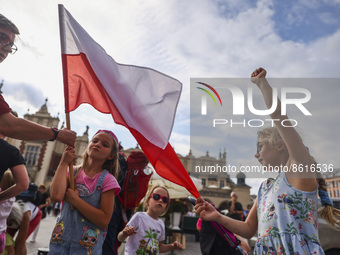 Children hold Polish flag celebrating the 76th anniversary of the Warsaw Uprising at the Main Square Krakow, Poland on 1st August, 2022. The...