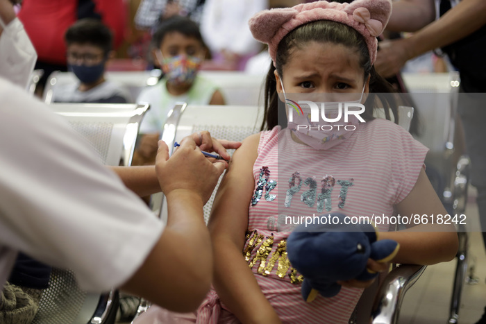 A child receives the first dose of Pfizer's during the pediatric vaccination campaign for children under 8 years of age   against Covid19 at...