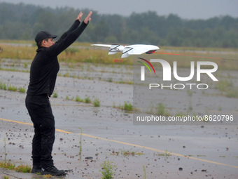 UKRAINE - AUGUST 2, 2022 - A man launches a SKIF drone that was made in Ukraine during the presentation of unmanned aerial vehicles for the...