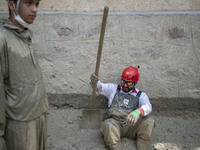 A member of the Iranian Red Crescent Society (IRCC) prepares to search for a body of a flood victim, five days after a sudden flooding in th...