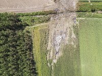 Aerial view from a drone of the scattered debris and the crash site of an Ukrainian made Antonov An-12 cargo plane with registration UR-CIC...