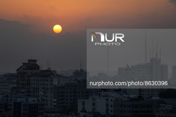 A picture taken on August 6, 2022 shows the sun rising over Gaza City.  