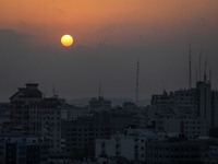 A picture taken on August 6, 2022 shows the sun rising over Gaza City.  (