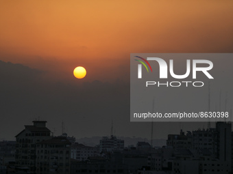 A picture taken on August 6, 2022 shows the sun rising over Gaza City.  (