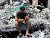 Palestinians inspect the ruins of a collapsed building destroyed by an Israeli air strike in Gaza City, on August 6, 2022. - Israel hit Gaza...