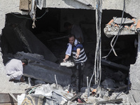 Palestinians inspect buildings damaged after Israeli airstrikes in Gaza City, on 06 August 2022.  (