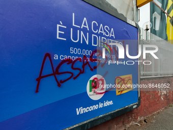 Billboards advertising the Democratic Party for the 25 September 2022 general election, vandalised with the words 'Assassins' in Via del Por...