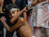 A Shi'ite Muslim boy flagellate himself during a Muharram procession to mark Ashura in Kolkata on August 09, 2022. After a gap of two years...