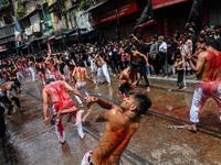 Shi'ite Muslim mourners flagellate themselves during a Muharram procession to mark Ashura in Kolkata on August 09, 2022. After a gap of two...