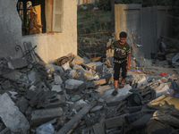 A Palestinian man inspects their damaged home in Gaza city early on August 9, 2022 after a ceasefire between Israel and Palestinian militant...