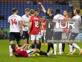 referee John Brooks shows a red card to George Thomason (25) of Bolton Wanderers during the Carabao Cup match between Bolton Wanderers and S...