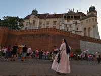 A local nun watches the protest outside Wawel Castle.
Members of the local Belarusian and Ukrainian diaspora supported by local Cracovians d...