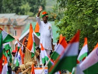 BJP Leader Anwar Khan waves towards party workers. BJP workers held Tri-Color (Tiranga) Rally in Baramulla Jammu and Kashmir India on 10 Aug...