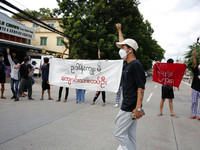 Young demonstrators shout slogans and hold banners during an anti-coup protest in Yangon, Myanmar on August 10, 2022.   (