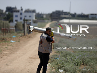 Explosives experts of Hamas they get rid of an unexploded Iron Dome missile, that fell in a field during in last week's Israeli air strikes,...