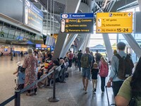 Waiting times fluctuate at Dutch airports during morning peak travel day time as passenger accumulate. Long queues of passenger waiting to p...