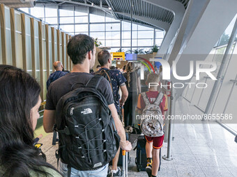 Waiting times fluctuate at Dutch airports during morning peak travel day time as passenger accumulate. Long queues of passenger waiting to p...