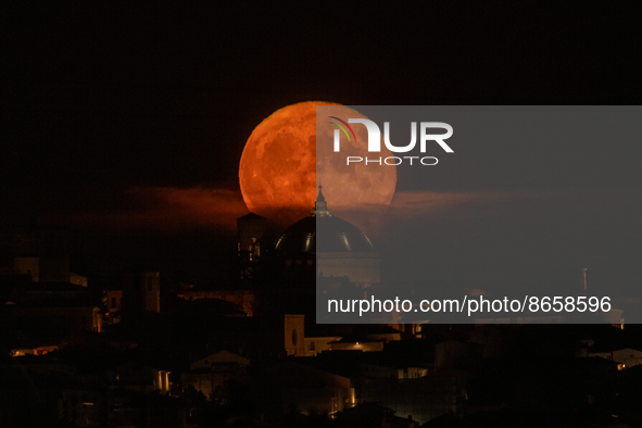A sturgeon Super Moon rising behind San Bernardino church dome in L'Aquila (Abruzzo, Italy), on august 12, 2022. August full moon is the las...